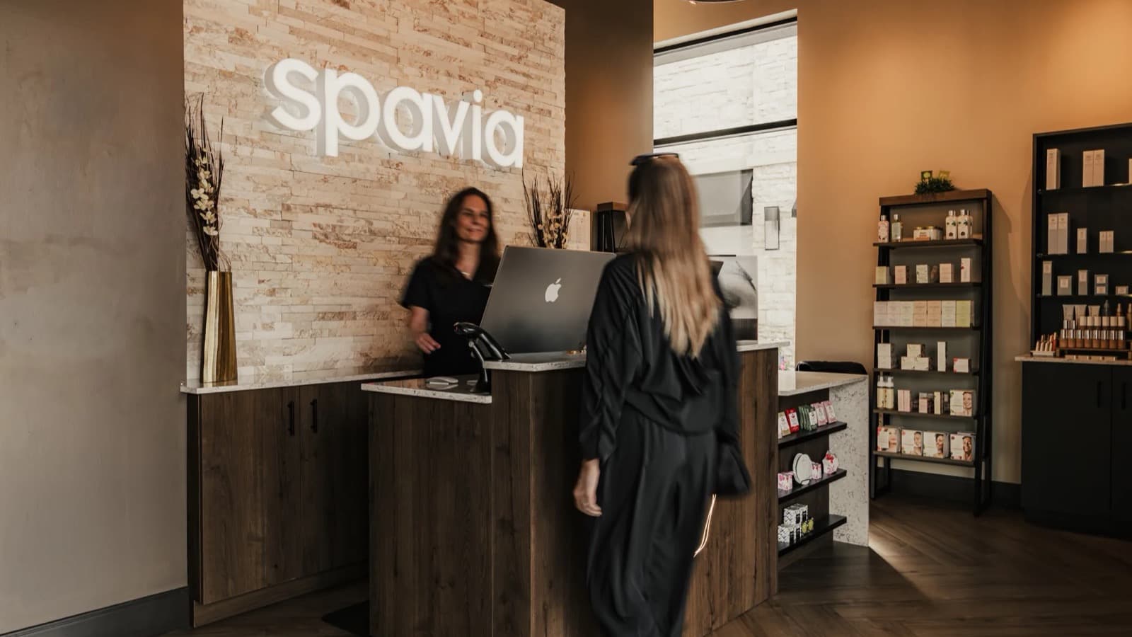 A guest checking in at the front desk of a Spavia day spa