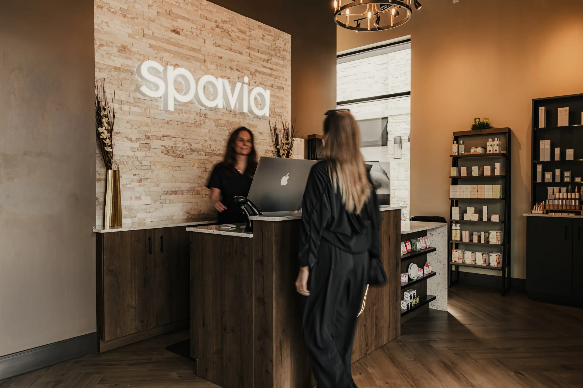 Spavia reception area with guest being greeted by a team member