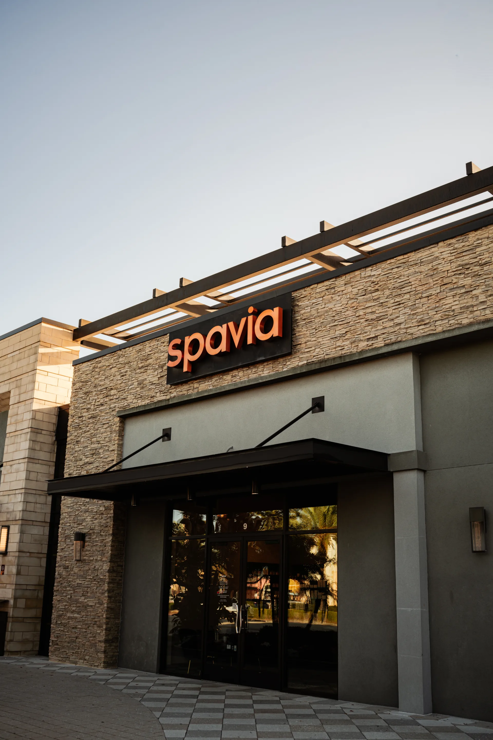 Spavia storefront exterior at dusk