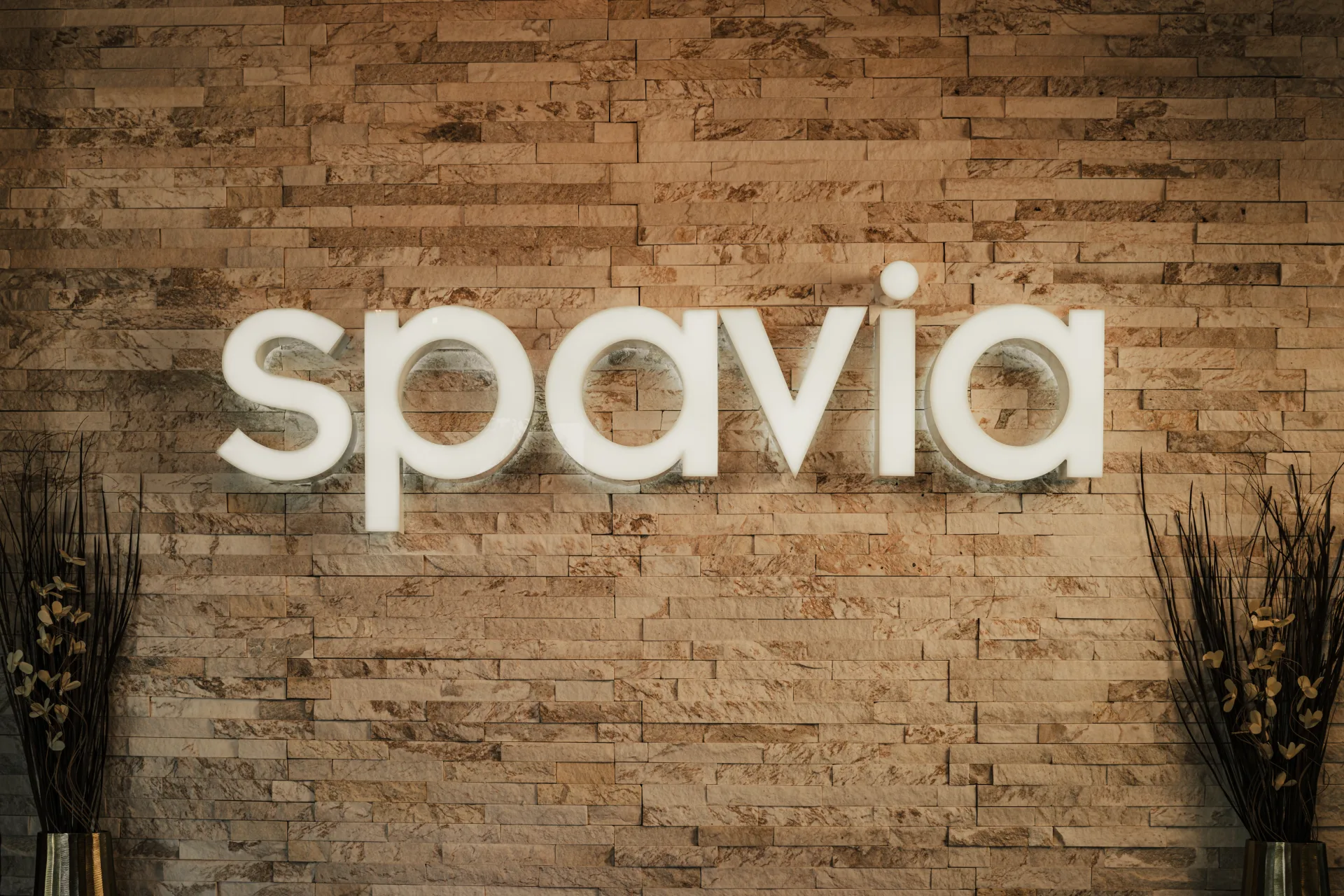 Spavia brand signage on a stone feature wall